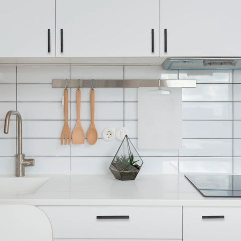 White kitchen with 10 Pack 5 Inch Matte Black Kitchen Cabinet Handles Knurled Cabinet Pulls visible on cabinets and drawers.