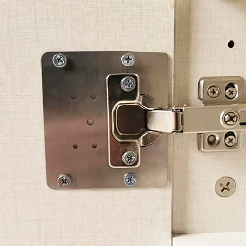 Close-up of Six Piece Hinge Repair Bracket Set For Cabinets And Cupboards With Pre Drilled Holes And Mounting Screws installed on a door