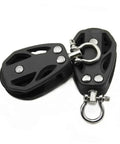 Port Side Sail Pulley Lifting Wheel For Sailboat Rope Rigging With U Groove Bearing Beefy Plastic Pulley For Heavy Duty Marine Use Corrosion Resistant Nylon And Steel Construction. Image of black pulley with U-groove and stainless steel fittings.