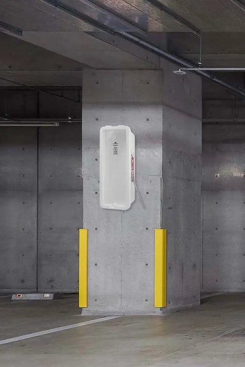 Ten Pack White Outdoor Fire Extinguisher Cabinet With Breaker Bar And Wall Mount For Twenty Pounds mounted on a concrete structure.