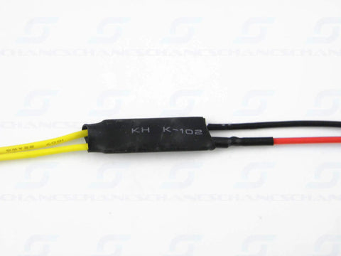 Close-up of yellow and black wires connected to a black electronic component labelled KH K-102, against a white background.