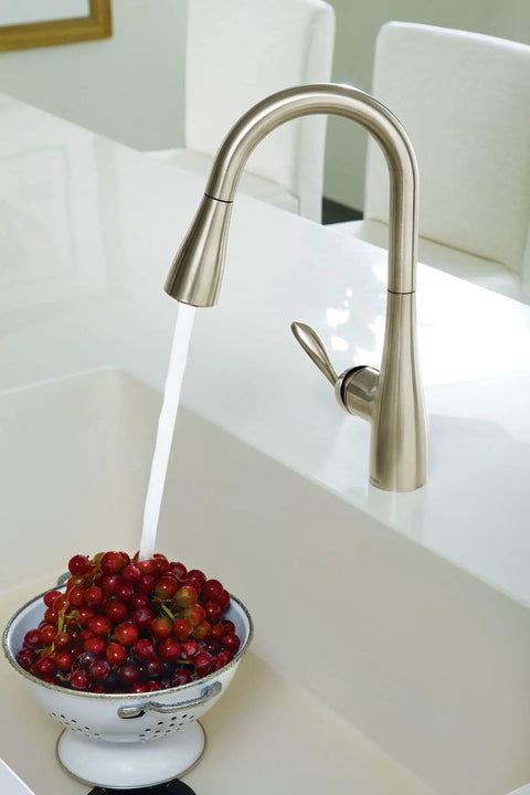 High Arc Pulldown Bar Faucet With One Handle Chrome Finish, Reflex Technology in use rinsing a bowl of berries in a kitchen sink