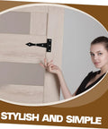 Black iron cabinet tee hinge installed on a light wood cabinet door