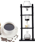 Kickstart Your Morning Routine With This Hella Smooth Cold Brew Coffee Tower Featuring A Slow Drip Ice Coffee Brewer With Adjustable Flow Control And Spacious Glass Container Pouring Five To Eight Cups Of Top Tier Chilled Java For Daily Office Use, showcasing glass brewer on a wood base.