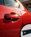 Heavy Duty Silicone Car Door Slam Buffers Four Pack on a red car, designed to reduce metal noise and vibration.