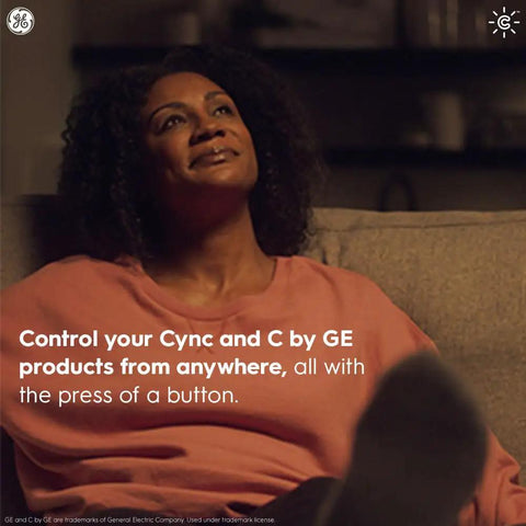Person relaxing at home with text about controlling Cync and C by GE products remotely using a smart remote.