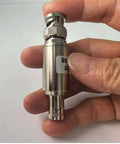 Hand holding 40 dB BNC Attenuator For Ham Radio And UHF Antennas 5W Power Handling Coax RF Attenuator, BNC male to female connector