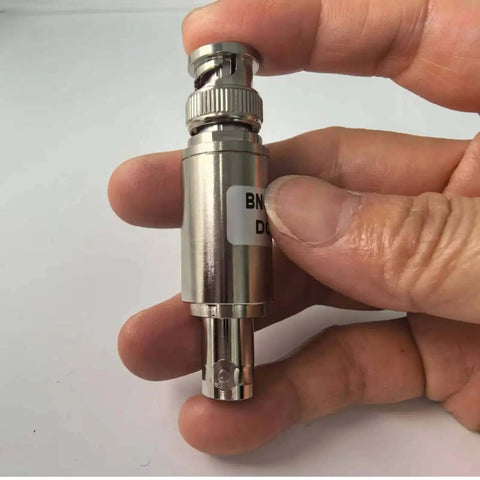 Hand holding 40 dB BNC Attenuator For Ham Radio And UHF Antennas 5W Power Handling Coax RF Attenuator, BNC male to female connector