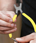 Person holding Single Hole Punch Handheld Metal Hole Puncher with yellow ergonomic grip for paper sheets, tags, and DIY projects