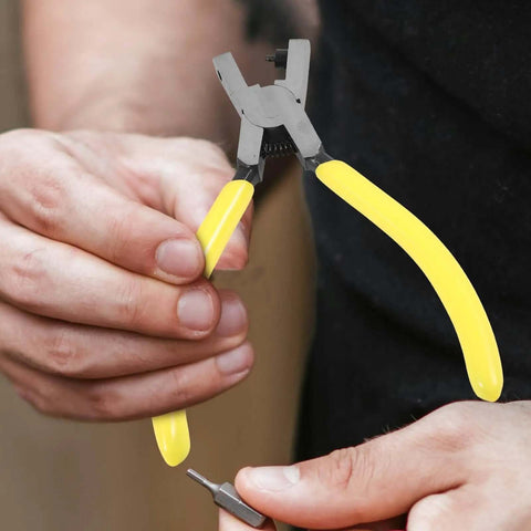 Handheld Single Hole Puncher Plier for Office and Craft Projects Do It All Tool with yellow handles, being held in hand