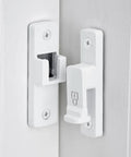 White 90 Degree Barn Door Lock With Right Angle Slide Latch For Sliding Wood Panels mounted on a door with screws.