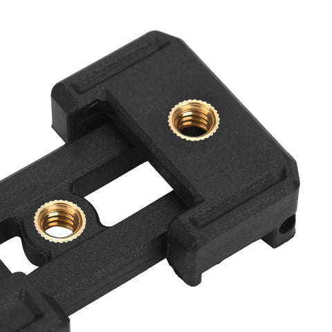 Close-up of a black plastic part featuring heavy duty heat set brass threaded inserts for 3D printing and prototyping.