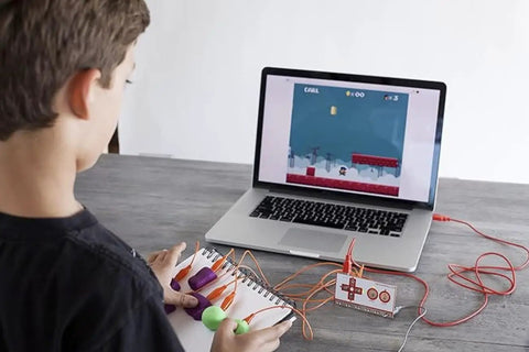 Hands On STEM Kit For Kids That Sparks Engineering And Coding Fun With Real Projects And Creative Challenges A Kid Friendly Awesome Learning Tool For Building Tech Skills At Home Or In Class. child using laptop with wired STEM controller
