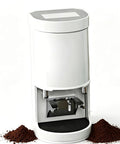 Total Game Changer 58mm Electric Coffee Tamper Featuring Automatic Espresso Press showing stainless steel base and coffee grounds.