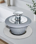 Happyyami Bathtub Drain Stopper Universal Fit 1.1 to 2.0 Inch Silicone in silver finish on a modern sink.