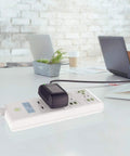 Universal AC Power Adapter For Korg Kross 61 Workstation And Synthesizers plugged into power strip on office desk