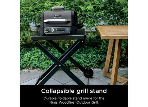 Woodfire Collapsible Outdoor Grill Stand For OG700 OG300 OO101 Series with grill, foldable legs, and utensil holder on patio.