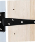 Close-up of Eight Pack 5 Inch Galvanized Black Tee Hinges for cabinets and shed doors, mounted on wood