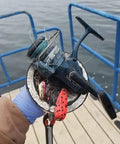 Magnet fishing catch using 1000 Lbs Neodymium Magnet Fishing Kit With Case, fishing reel on double-sided magnet, near water.