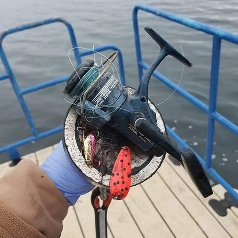 Magnet fishing catch using 1000 Lbs Neodymium Magnet Fishing Kit With Case, fishing reel on double-sided magnet, near water.