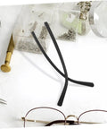 Eyewear Repair Kit With Replacement Temple Arms Screws And Lanyard For Glasses, Quick And Easy Eyeglass Frame Fix Kit on a table