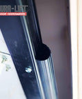 DURA-LIFT rubber weather seal installed on garage door edge; close-up view of seal and metal frame.