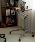 Upgrade Your Home Office Setup With This Smooth Riding Mobile Standing Desk That Dials In Your Perfect Height Fast For Seamless Sit Or Stand Flexibility Wherever You Roll, showcasing a wooden top, grey base, and wheels.