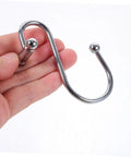 Hand holding a single 12 Piece Rust Resistant Shower Curtain Hook Curved Ring for Bathroom and Window Curtains.