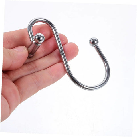 Hand holding a single 12 Piece Rust Resistant Shower Curtain Hook Curved Ring for Bathroom and Window Curtains.
