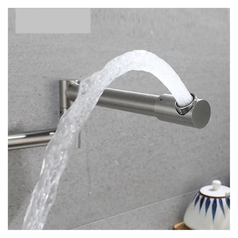 Foldable Wall-Mount Kitchen Faucet - Brushed Stainless Steel, Expandable & Retractable, water flowing from spout against a gray wall.