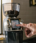 Heavy Duty Commercial Coffee Grinder Featuring Flat Steel Burrs And 260 Grind Settings For Espresso And Pour Over Brewing, control panel in use.