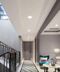 10 Pack 7W Led Recessed Ceiling Downlights Dimmable Round Panel With Polished Stainless Trim illuminating a modern hallway.