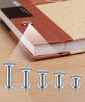 Hella Durable 160 Piece Chicago Screw And Binding Post Set Crafted For Heavy Duty Leather Projects And Photo Book Binding Featuring M4 M5 Size Compatibility With Anti Rust Nickel Finish displayed next to a notebook.
