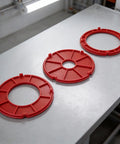 Rock Solid Router Table Insert Rings 3 Piece Set For Bosch RA1171 RA1180 RA1181 Models red replacement rings on a table.