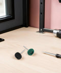 Trendy 100 Piece Mini Buffing Wheel Kit With T-Shaped Design For Drills featuring black and green scouring pads on a workbench.