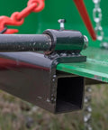 Close-up of Hay Bale Spear Frame Attachment with chain detail for Universal Front Loader Buckets. Heavy Duty 3000 Lb Capacity.