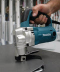 Using 10 Gauge Sheet Metal Shear With Low Noise 81 dB, 2-Inch Cut Radius on a metal sheet, shown in action.