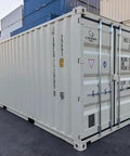 New 20 Foot Beefy Heavy Duty Steel Shipping Container For Secure Storage And Easy Transport Ideal For Modular Construction Projects And Onsite Storage Solutions showing closed dual doors on a construction site.