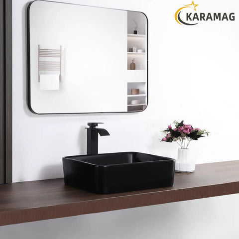 Matte Black Rectangle Vessel Sink 19 By 15 Inch Above Counter Bathroom Sink Porcelain Ceramic Small Bowl For Bathrooms Modern Sleek Dope European Inspired Style Durable Black Ceramic Vessel For Contemporary Vanities on wooden countertop with mirror reflection