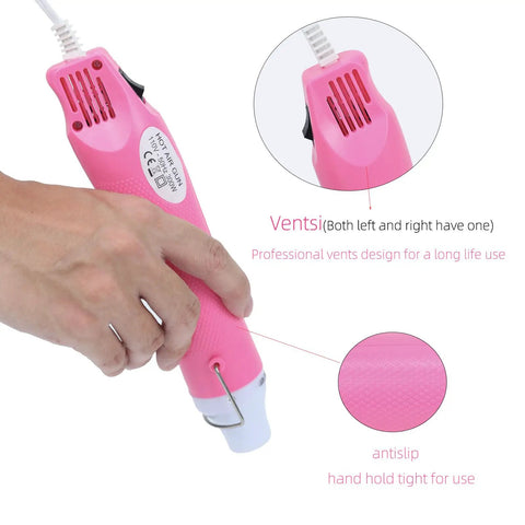 Close-up of DIY Heat Gun For Crafting And Home Projects, 110V 300W Handheld Hot Air Tool in pink, showing vents and anti-slip grip.