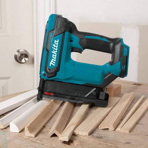 Cordless 18V LXT 23 Gauge Pin Nailer Pro Grade on table with trim pieces, drives six lengths, woodworking tool.