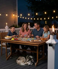 Family dining at night on a deck with Built In Torch Holder For Tiki Torches On Your Deck Tool Free Click On Installation Wind Resistant Secure Fit Lets You Run Ambient Or Citronella Lighting Without Screws Or Drilling Easy Post Mount For Standard Deck Posts visible on railing.