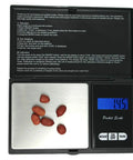 Mini Stainless Steel Digital Pocket Scale 0.01g To 500g With Tare Function displaying 1.45g with seeds on platform