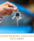 Hand holding Must Have Travel Themed Keychain In Silver Zinc Alloy With Sturdy Build And Easy Clip Attach The Go To Accessory