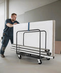 Man using Beefy Heavy Duty Folding Table Cart With 1800 Lb Load Capacity, Steel Table Dolly On 5 Inch Swivel Casters, Straps For Safe Transport