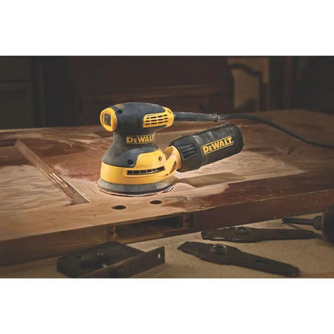 5 Inch Orbital Sander With 3.0 Amp Motor Delivers 12,000 OPM on wood surface, highlighting compact palm sander close to workpiece