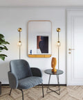 Plug In Wall Sconce Set Of 2 Modern Glass Globe Lights With Brushed Brass Finish displayed in living room setting