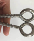 Close-up of two M8 heavy duty swing hooks eye screws, 4 Pack M8 Heavy Duty Swing Hooks Eye Screws 1200Lb Capacity Hammock Hanging Kit, stainless steel.