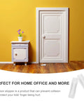 Door Stop Wedges Set Of 10 Non Skid Buffers For Home And Office Floor Friendly Stops That Protect Pets And Kids Prevent Door Slams And Floor Damage Lightweight Adhesive Wall Saver For Easy Everyday Use beside a white door and cabinet on wooden floor with yellow wall background