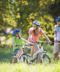 Family biking together in a park with helmets and casual clothing
